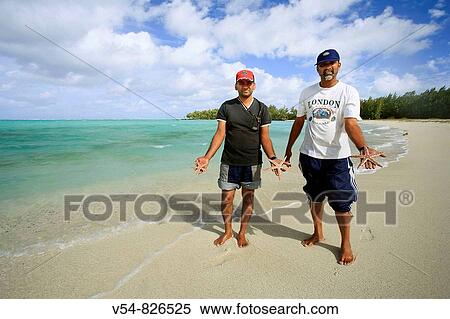 Stock Photography - Local men with starfish, Ile aux Cerfs, Mauritius, Indian Ocean. Fotosearch