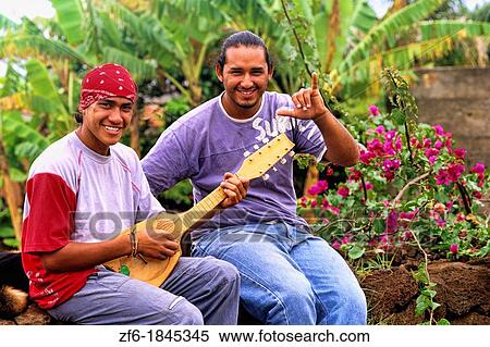 Stock Photography - Local native men playing music Easter Island during Tapati Festival Rapa Nui. Fotosearch