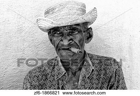 Local old man with cigar against bright yellow wall of building of the old colonial city of Trinidad in Cuba View Large Photo Image Stock Image - Local old man with cigar against bright yellow wall of building of the old colonial city of Trinidad in Cuba. Fotosearch