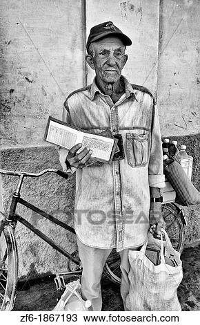 Stock Image - Local people getting government rations of milk in small town outside of Havana Habana Cuba. Fotosearch