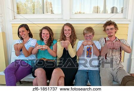 Local teenagers on porch showing knuckle tats in small town of Three Forks Montana View Large Photo Image Stock Photo - Local teenagers on porch showing knuckle tats in small town of Three Forks Montana. Fotosearch