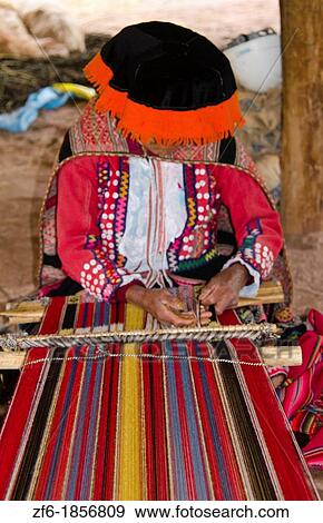 Local woman in the Sacred Valley Peru weaving with yarn in traditional clothes and methods of working View Large Photo Image Stock Photo - Local woman in the Sacred Valley Peru weaving with yarn in traditional clothes and methods of working. Fotosearch