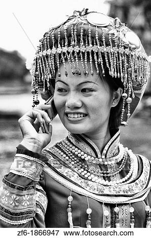 Local woman in traditional costume having communication with cell phone portrait in Guilin area of China View Large Photo Image Stock Photo - Local woman in traditional costume having communication with cell phone portrait in Guilin area of China. Fotosearch