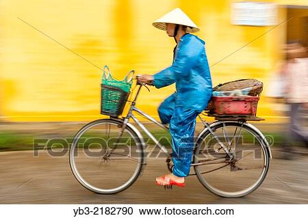 Local Woman Riding A Bicycle, Hoi An, Quang Nam Province, Vietnam. View Large Photo Image Stock Image - Local Woman Riding A Bicycle, Hoi An, Quang Nam Province, Vietnam.. Fotosearch