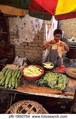 Local woman selling vegetable in unique Guilin Yangshuo area of China. View Large Photo Image Picture - Local woman selling vegetable in unique Guilin Yangshuo area of China.. Fotosearch