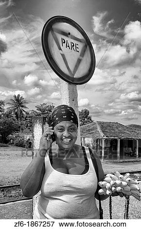 Local woman talking on cell phone in small village of Trinidad Cuba with Stop sign Pare View Large Photo Image Stock Photo - Local woman talking on cell phone in small village of Trinidad Cuba with Stop sign Pare. Fotosearch