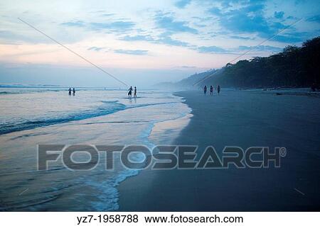 Locals and visitors gather at Santa Teresa beach to watch the sunset, Costa Rica. View Large Photo Image Stock Photo - Locals and visitors gather at Santa Teresa beach to watch the sunset, Costa Rica.. Fotosearch