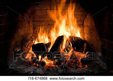 Log fire burning in an open brick fireplace View Large Photo Image Stock Photo - Log fire burning in an open brick fireplace. Fotosearch