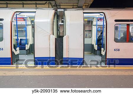 London, England, UK, United Kingdom, Britain. Arriving and leaving underground trains, parked at a platform of underground station? Acton Town?, London South-West. View Large Photo Image Stock Photography - London, England, UK, United Kingdom, Britain. Arriving and leaving underground trains, parked at a platform of underground station? Acton Town?, London South-West.. Fotosearch
