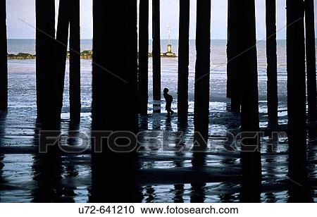 Lone Little Boy Amongst Pillars by Sea, England, United Kindom View Large Photo Image Stock Image - Lone Little Boy Amongst Pillars by Sea, England, United Kindom. Fotosearch