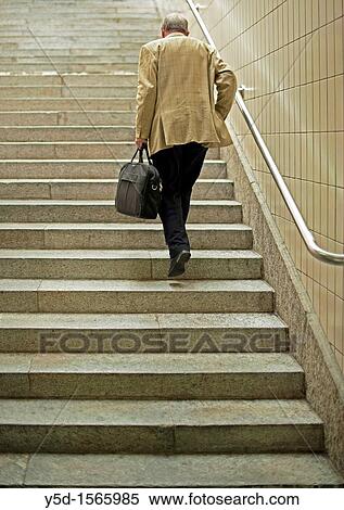 lonely traveller climbing the stairs View Large Photo Image Stock Photography - lonely traveller climbing the stairs. Fotosearch