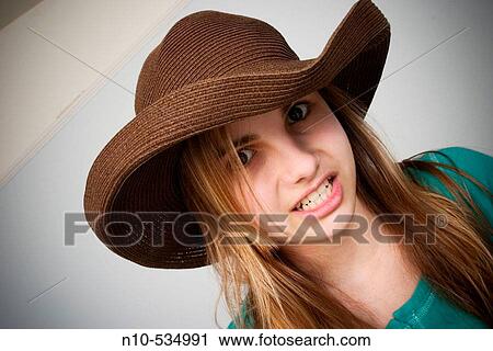 Long blond-hair teen girl wearing a hat View Large Photo Image Stock Image - Long blond-hair teen girl wearing a hat. Fotosearch
