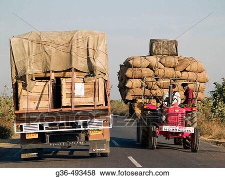 Long distance delivery trucks delivering goods in Rajasthan, India View Large Photo Image Stock Photo - Long distance delivery trucks delivering goods in Rajasthan, India. Fotosearch