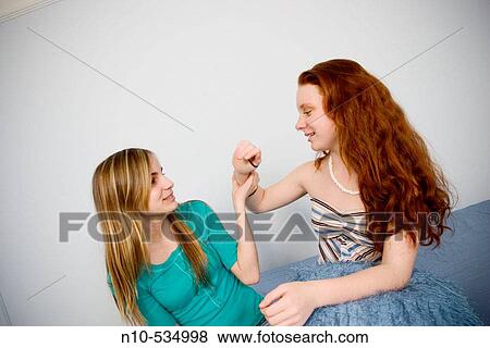 Long red-hair and blond-hair teen girls clowning around together View Large Photo Image Stock Photo - Long red-hair and blond-hair teen girls clowning around together. Fotosearch