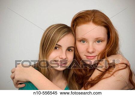Long red-hair and blond-hair teen girls hugging each other. View Large Photo Image Stock Photography - Long red-hair and blond-hair teen girls hugging each other.. Fotosearch