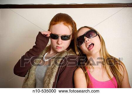Long red-hair and blond-hair teen girls, both wearing sunglasses, clowning around together View Large Photo Image Stock Image - Long red-hair and blond-hair teen girls, both wearing sunglasses, clowning around together. Fotosearch
