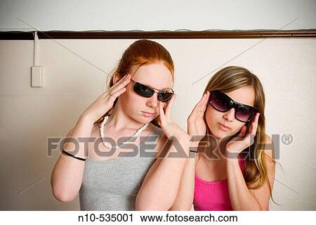 Long red-hair and blond-hair teen girls, both wearing sunglasses, clowning around together View Large Photo Image Stock Image - Long red-hair and blond-hair teen girls, both wearing sunglasses, clowning around together. Fotosearch