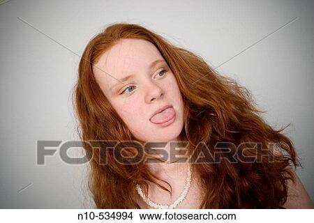 Long red-hair teen girl sticking out her tongue View Large Photo Image Picture - Long red-hair teen girl sticking out her tongue. Fotosearch