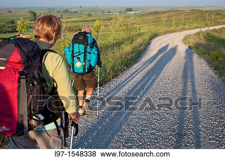 Long shadows of pilgrims walking the Camino de Santiago View Large Photo Image Stock Photo - Long shadows of pilgrims walking the Camino de Santiago. Fotosearch