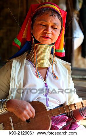 Longneck Karen woman sitting and playing guitar, Mae Hong Son, Thailand, Southeast Asia. View Large Photo Image Stock Photo - Longneck Karen woman sitting and playing guitar, Mae Hong Son, Thailand, Southeast Asia.. Fotosearch