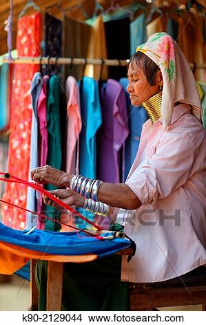 Longneck Karen woman sitting on the chair and weaving a scarf, Mae Hong Son, Thailand, Southeast Asia. View Large Photo Image Picture - Longneck Karen woman sitting on the chair and weaving a scarf, Mae Hong Son, Thailand, Southeast Asia.. Fotosearch