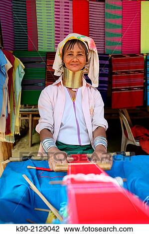 Longneck Karen woman sitting on the floor in her stall and weaving a scarf, Mae Hong Son, Thailand, Southeast Asia. View Large Photo Image Stock Image - Longneck Karen woman sitting on the floor in her stall and weaving a scarf, Mae Hong Son, Thailand, Southeast Asia.. Fotosearch
