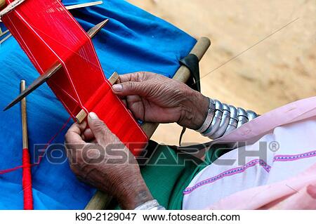 Longneck Karen womanweaving a red scarf, Mae Hong Son, Thailand, Southeast Asia. View Large Photo Image Stock Photo - Longneck Karen womanweaving a red scarf, Mae Hong Son, Thailand, Southeast Asia.. Fotosearch
