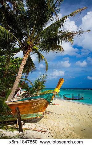 Stock Image - Longtail boat on Long beach Phi Phi Don island Krabi province, Andaman Sea, Thailand. Fotosearch