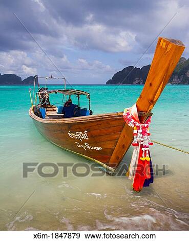 Stock Photo - Longtail boat on Long beach Phi Phi Don island Krabi province, Andaman Sea, Thailand. Fotosearch