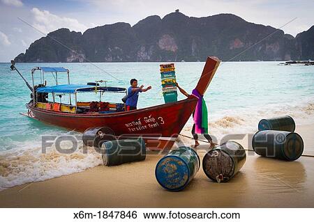 Stock Photograph - Longtail boat on Long beach Phi Phi Don island Krabi province, Andaman Sea, Thailand. Fotosearch