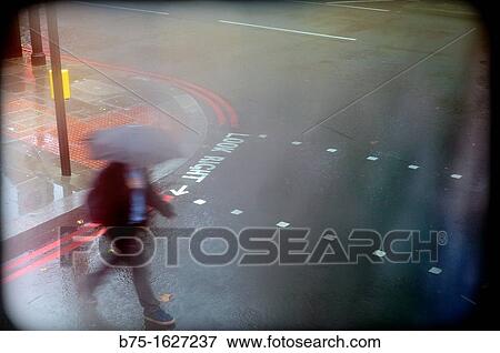 ??look right??, man crossing the street with an umbrella View Large Photo Image Stock Photo - ??look right??, man crossing the street with an umbrella. Fotosearch