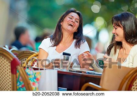 Looking a smartphone. Women sisters 35 and 40 years taking coffee on a terrace. Donostia. San Sebastian. Gipuzkoa. Basque Country- Spain. View Large Photo Image Stock Photo - Looking a smartphone. Women sisters 35 and 40 years taking coffee on a terrace. Donostia. San Sebastian. Gipuzkoa. Basque Country- Spain.. Fotosearch