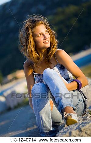 Looking at a setting sun young teen woman View Large Photo Image Picture - Looking at a setting sun young teen woman. Fotosearch
