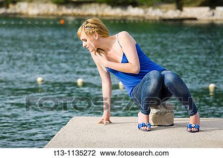 Looking down over the edge into the sea blonde woman View Large Photo Image Stock Image - Looking down over the edge into the sea blonde woman. Fotosearch