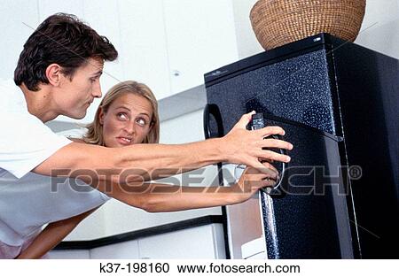 Looking in fridge & making dinner decisions View Large Photo Image Stock Image - Looking in fridge & making dinner decisions. Fotosearch