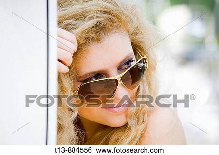 Looking over shoulder attractive young woman with long curly hair portrait View Large Photo Image Stock Photograph - Looking over shoulder attractive young woman with long curly hair portrait. Fotosearch