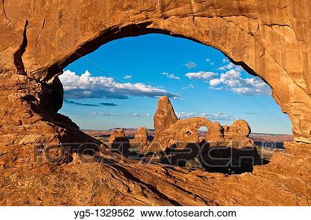 Looking through the NORTH WINDOW rock arch on the TURRET ARCH rock formation in the morning, Arches National Park, Utah, USA View Large Photo Image Stock Image - Looking through the NORTH WINDOW rock arch on the TURRET ARCH rock formation in the morning, Arches National Park, Utah, USA. Fotosearch