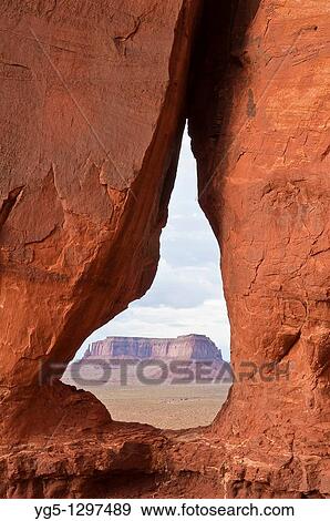 Looking through the Teardrop Arch towards the Mesas in Monument Valley, Arizona, USA. View Large Photo Image Stock Photo - Looking through the Teardrop Arch towards the Mesas in Monument Valley, Arizona, USA.. Fotosearch