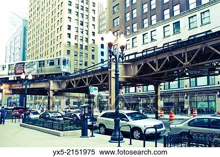Stock Photography - Loop train riding above a street in Chicago.. Fotosearch