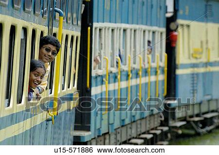 Loughing girls looking out of the train windows of the Nilgiri Mountain Railway driving from Coonoor to Ooty. Tamil Nadu, India 2005. View Large Photo Image Stock Photograph - Loughing girls looking out of the train windows of the Nilgiri Mountain Railway driving from Coonoor to Ooty. Tamil Nadu, India 2005.. Fotosearch