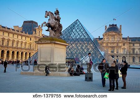 Louis XIV statue Sun King and Crystal Piramid in front of the Louvre Museum Paris, France View Large Photo Image Stock Photography - Louis XIV statue Sun King and Crystal Piramid in front of the Louvre Museum Paris, France. Fotosearch