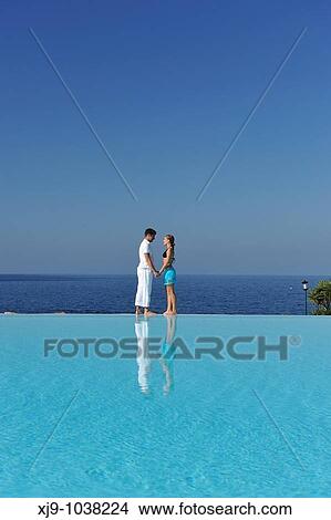 Love face to face with infinity pool reflection View Large Photo Image Picture - Love face to face with infinity pool reflection. Fotosearch