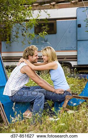 Stock Photo - Loving couple in a Camping looking eachother. Fotosearch
