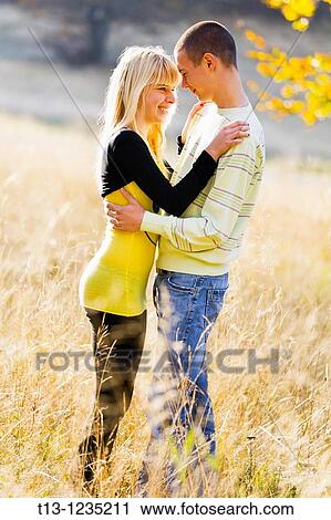 Loving couple in a grassland View Large Photo Image Stock Image - Loving couple in a grassland. Fotosearch