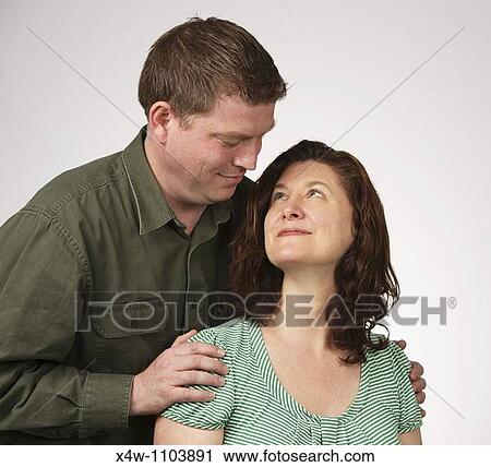 Stock Image - Loving married heterosexual couple looking at each other romantically. Fotosearch