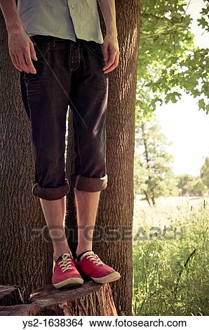 Lower section of young man in woods View Large Photo Image Picture - Lower section of young man in woods. Fotosearch