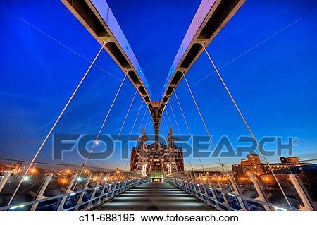 lowry pedestrian suspension footbridge and office block night dusk evening salford quays manchester england uk europe View Large Photo Image Stock Photography - lowry pedestrian suspension footbridge and office block night dusk evening salford quays manchester england uk europe. Fotosearch