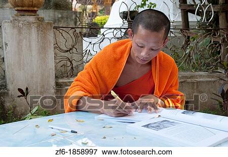Stock Photo - Luang Phabang Laos Lao monk relaxing and writing portrait in garden Asia Asian. Fotosearch