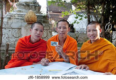 Luang Phabang Laos Lao young monks relaxing with Polaroid portrait in garden Asia Asian View Large Photo Image Stock Photo - Luang Phabang Laos Lao young monks relaxing with Polaroid portrait in garden Asia Asian. Fotosearch