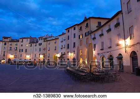 Stock Image - Lucca, Anfiteatro square at Dusk, Piazza Anfiteatro, Tuscany, Italy.. Fotosearch